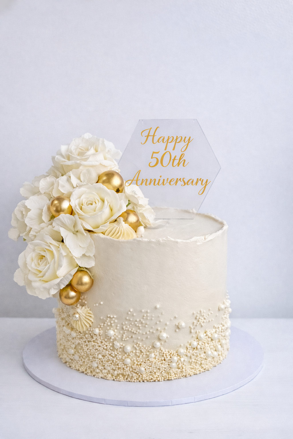 Elegant pearl and floral anniversary cake
